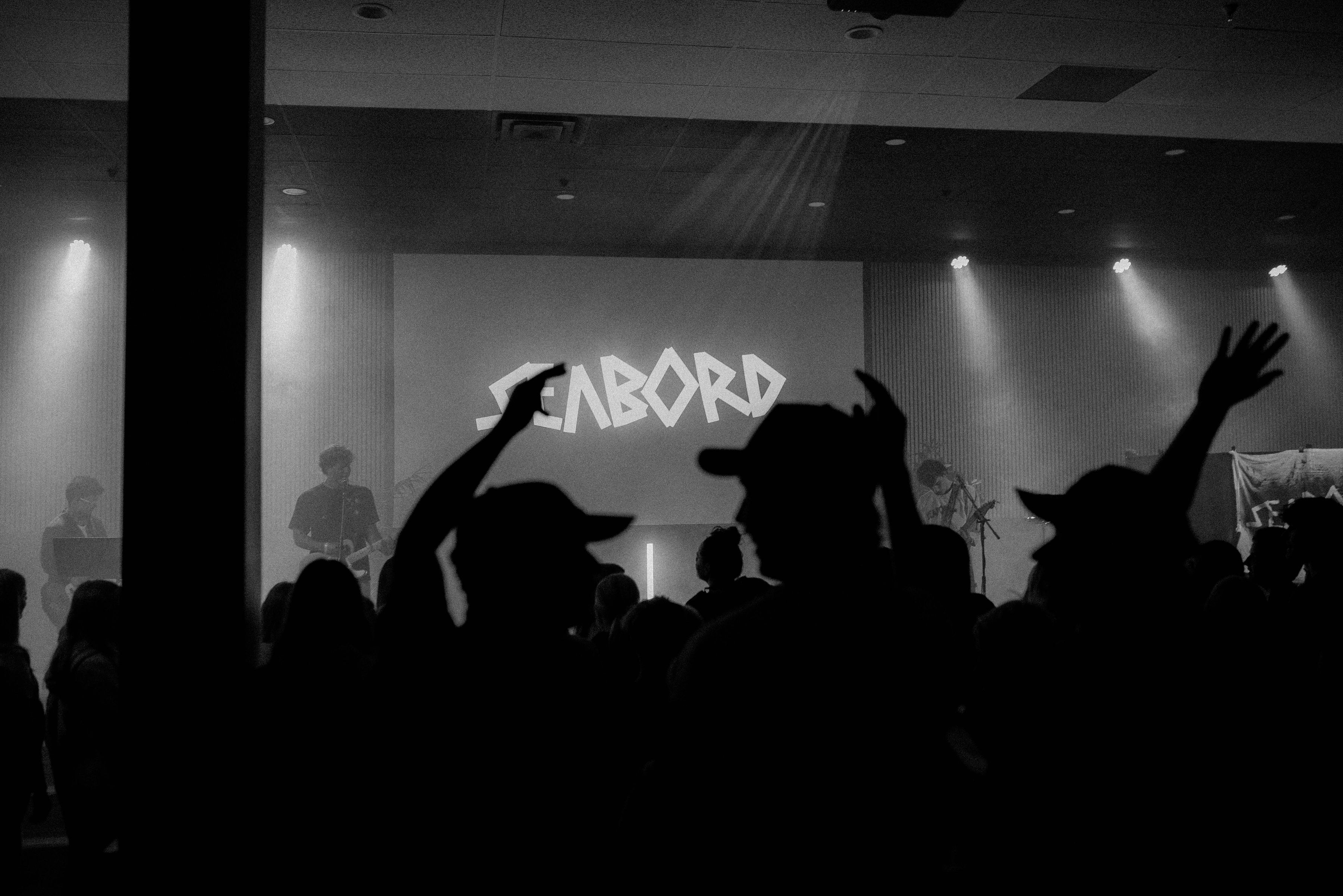 Fans raising their hands during a SEABORD performance